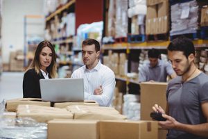 People reviewing logistics on a computer