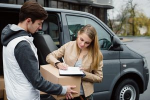 Woman signing for a package delivered by a logistics company in Minneapolis