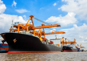 An image of a cargo shipping vessel at the port