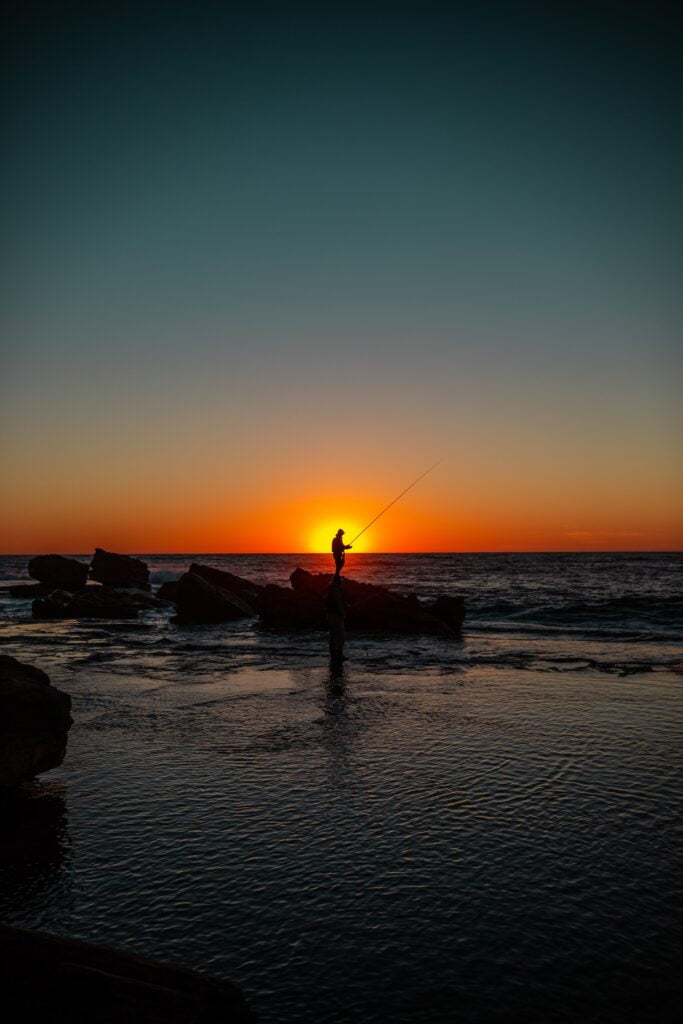 Image of a fisherman in the sunrise