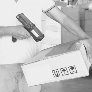 An image of a person scanning an SKU on a package to prepare for shipping