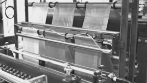 An image of plastic being run through a machine in preparation for manufacturing and distribution
