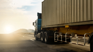 An image of a semi truck hauling a shipping container. Drayage service is a critical component of getting goods into customers hands.